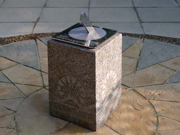 stainless sundial showing clear reflections in the polished surface