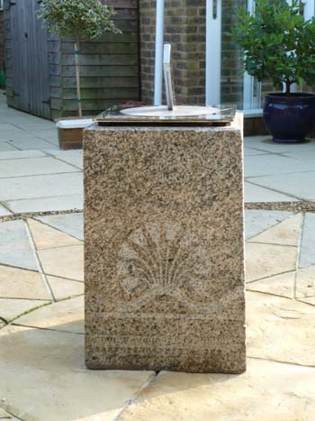 Staainless sundial on a four-legged plinth