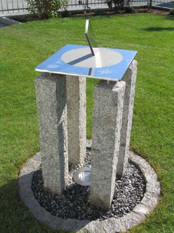 Staainless sundial on a four-legged plinth